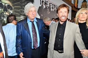 Chuck Norris con traje gris y camisa negra
