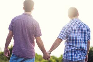 Casal gay anda de mãos dadas