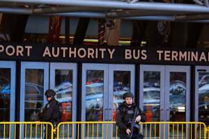 Police officers stand outside the New York Port Authority Bus Terminal in New York City after reports of an explosion.