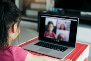 Little asian girl attending to online e-learning platform class from home while school has been closed during coronavirus outbreak.