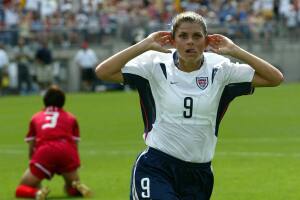 Mia Hamm (R) of the US asks for some noi