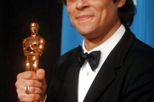 Actor Benicio Del Toro holds his Oscar for Best Su