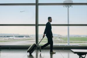 Businessman with suitcase walking in airport