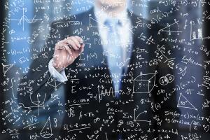 business person is writing down math formulas