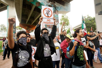 SAN DIEGO, CA - SEPTEMBER 03: Latino Protesters chant during a solidarity rally against White Supremesist activists during a rally at Chicano Park on September 3, 2017 in San Diego, California. White rights activists want to take down historic Chicano murals depicting Latino themes from the park, which was just named as a National Historic Landmark by the U.S. Secretary of the Interior in January of this year.(Photo by Sandy Huffaker/Getty Images)