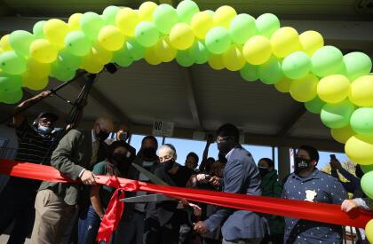 EL SOBRANTE, CALIFORNIA - SEPTEMBER 22: Betty Reid Soskin, (C) the oldest full-time National Park Service ranger in the United States, uses large scissors to cut a ribbon during a renaming ceremony for the newly named Betty Reid Soskin Middle School on September 22, 2021 in El Sobrante, California. Soskin had the school renamed after her on her 100th birthday. She currently works at the Rosie the Riveter/World War II Home Front National Historical Park where she leads tours, speaks to groups and answers questions about living and working in the area during the World War Two. Soskin worked as a clerk for the Boilermakers A-36 in Richmond, California during the war. (Photo by Justin Sullivan/Getty Images)