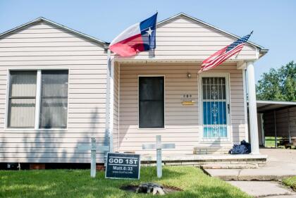 A house with the US and Texas state flag is seen in Port Arthur, Texas on September 1, 2017. Houston was limping back to life on Friday one week after Hurricane Harvey slammed into America's fourth-largest city and left a trail of devastation across other parts of southeast Texas. As flood waters receded in Houston and residents began slowly returning home other nearby towns such as Rockport, Beaumont and Port Arthur were struggling to get back on their feet. / AFP PHOTO / Emily Kask (Photo credit should read EMILY KASK/AFP via Getty Images)