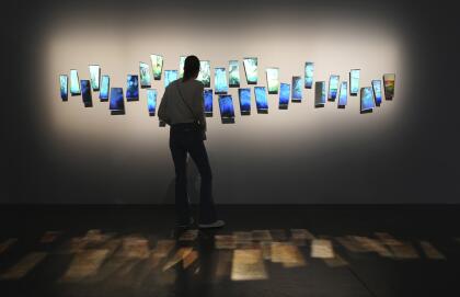 Histograms, mirrored glass and aluminum titled "Interference #18," by artist Sarah Meyohas, are displayed during Miami Basel Miami Beach Wednesday, Dec. 4, 2024, in Miami Beach, Fla. (AP Photo/Lynne Sladky)