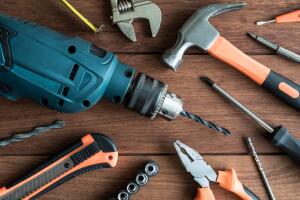Set of work tools on wooden background