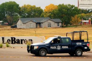 A federal police drives pass the entrance of LeBaron