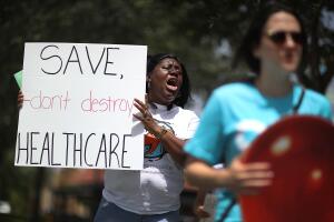Activists Protest Healthcare Vote Of GOP Rep. Carlos Curbelo In Miami