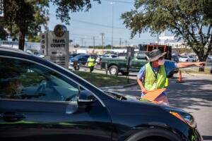 Un empleado dirige el tráfico hacia un punto de recepción de boletas electorales el 13 de octubre de 2020 en Austin, Texas.