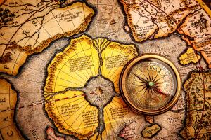 Vintage compass lies on an ancient map of the North Pole (also Hyperborea). Arctic continent on the Gerardus Mercator map of 1595. GRosby (2).jpg