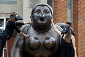 A group of environmentalists place gas masks on the faces of the sculptures of the artist Fernando Botero, protesting the high levels of air pollution in Medellin
