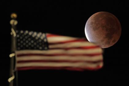 The earth's shadow covers the full moon during a partial lunar eclipse, Friday, Nov. 19, 2021, in Kansas City, Mo. (AP Photo/Charlie Riedel)