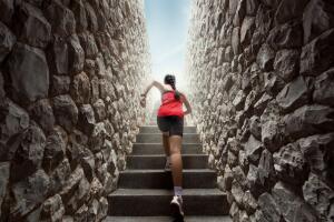Women are exercising by running up the stairs.