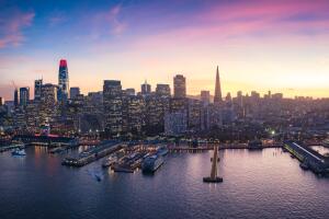 Colorful aerial panorama of San Francisco downtown and waterfront at sunset. California, USA.
