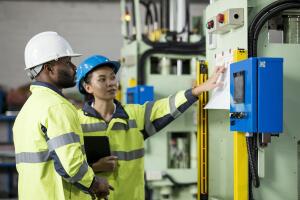 Root Cause Analysis & Manufacturing Troubleshooting. Diversity of Production Control Engineers are discussing a process control plan used to define the control product item in each production process step.