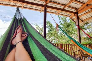 Low section of woman lying in hammock