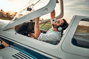 Young pilot is preparing for take off with private plane