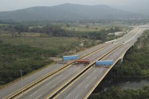 A fuel tanker, cargo trailers and makeshift fencing, blocking the Tienditas International Bridge to stop humanitarian aid entering from Colombia, Feb. 6, 2019.