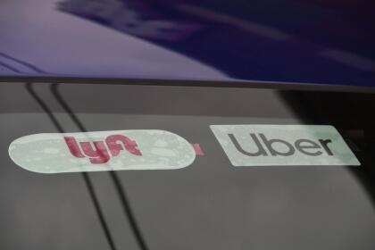 Rideshare drivers demonstrate against rideshare companies Uber and Lyft during a car caravan protest on August 6, 2020 in Los Angeles. - The drivers, organized by the Mobile Workers Alliance and Rideshare Drivers United unions, say Uber and Lyft's are pushing a "deceptive" November ballot initiative, which, if passed, they claim would "rewrite labor law" and turn app-based drivers into independent contractors, exempting companies such as Lyft and Uber from standard wage and hour restrictions. (Photo by Robyn Beck / AFP) (Photo by ROBYN BECK/AFP via Getty Images)