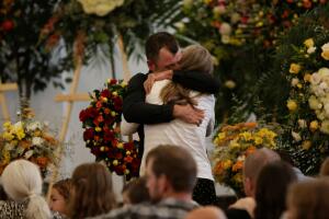 Tyler Johnson, husband of Christina Marie Langford Johnson, who was killed by unknown assailants, hugs a relative during her funeral service, before a burial at the cemetery in LeBaron, Chihuahua