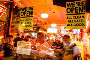 A group of patrons enjoy drinks inside Brothers Bar and
