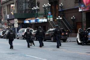 Police officers stand on a closed West 42nd Street near the New York Port Authority Bus Terminal after reports of an explosion in New York City