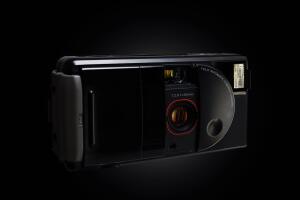 real 35mm plastic point and shoot camera on black background