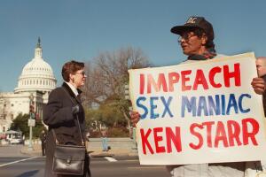 Loree Murray marches with a sign conveying her fee
