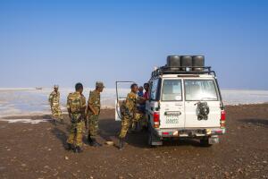 Policemen and a tourist four wheels on a salt lake, Afar region, Dallol, Ethiopia