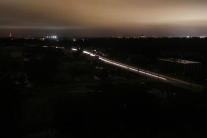 LAFAYETTE, LOUISIANA - OCTOBER 09: (EDITORS NOTE: Long Exposure) Cars move through a section of the city suffering a power outage during Hurricane Delta on October 9, 2020 in Lafayette, Louisiana. Hurricane Delta made landfall as a Category 2 storm in Louisiana today leaving some 300,000 customers without power. (Photo by Mario Tama/Getty Images)