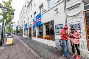 Street road sidewalk in downtown center and flags sign for Austur nightclub and couple lost