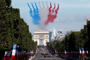 Alpha jets from the French Air Force Patrouille de France fly over the Champs-Elysees avenue during the traditional Bastille Day military parade in Paris