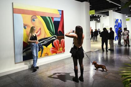 Show attendees snap a photo at day 2 of Art Basel on Thursday, Dec. 5, 2024, at Miami Beach Convention Center in Miami Beach. (Photo by Scott Roth/Invision/AP)