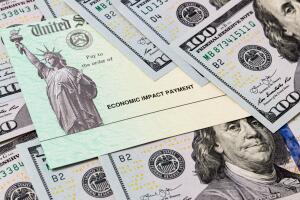 Coronavirus economic impact check surrounded by money. Concept of stimulus payment and United States government assistance