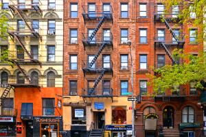 Colorful classic old buildings, architecture and facade with windows, balcony and small shops in east village Manhattan, New York City