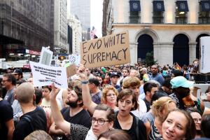 Protesters wave anti-racism signs during protests in front of Trump Tower in New York City