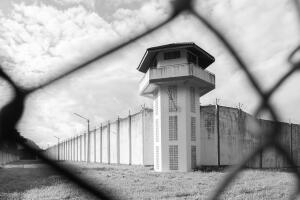 Prison with iron fences.Prison or jail is a building where people are forced to live if their freedom has been taken away.Prison is the building use for punishment prisoner.