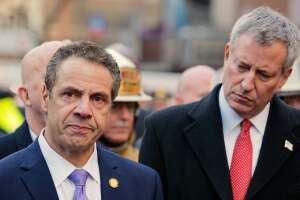 New York mayor Billl de Blasio looks on as New York governor Andrew Cuomo holds a press conference in the wake of an explosion at the Port Authority in New York City after reports of an explosion.