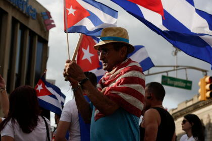 A man holds a Cuban flag during a protest showing support for Cubans demonstrating against their government, in Union City, New Jersey, on July 18, 2021. - Cuba's President Miguel Diaz-Canel on July 17 denounced what he said was a false narrative over unrest on the Caribbean island, as the Communist regime vigorously pushed back against suggestions of historically widespread discontent. (Photo by Kena Betancur / AFP) (Photo by KENA BETANCUR/AFP via Getty Images)