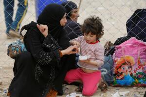 Displaced Iraqis who had fled their homes are seen waiting for transfer to eastern Mosul, after their arrivial at Hammam al-Alil camp check point south of Mosul