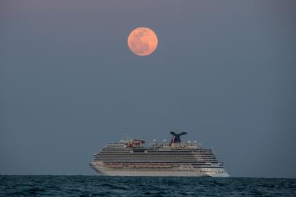 The Carnival Vista cruise ship is seen sailing during a Super Pink Full Moon in Miami Beach, on April 26, 2021. (Photo by CHANDAN KHANNA / AFP) (Photo by CHANDAN KHANNA/AFP via Getty Images)