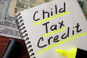Notebook with child tax credit  sign on a table.
