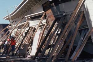 Emergency workers prop up a collapsed building