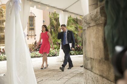 President-elect Donald Trump's Chief of Staff Reince Priebus, right, accompanied by Madeleine Westerhout of the Republican National Committee, left, arrive at Mar-a-Lago, in Palm Beach, Fla., Wednesday, Dec. 21, 2016. (AP Photo/Andrew Harnik)