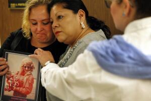 LOS ANGELES, CA  SEPTEMBER 24, 2014 - Pearl Nelson, 38, left, is holding a photo of her mother victi