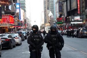 Police officers stand on a closed West 42nd Street near the New York Port Authority Bus Terminal after reports of an explosion in New York City