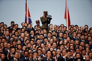 A soldier films North Korean soldiers, officers and high ranking officials attending a military parade marking the 105th birth anniversary of country's founding father in Pyongyang